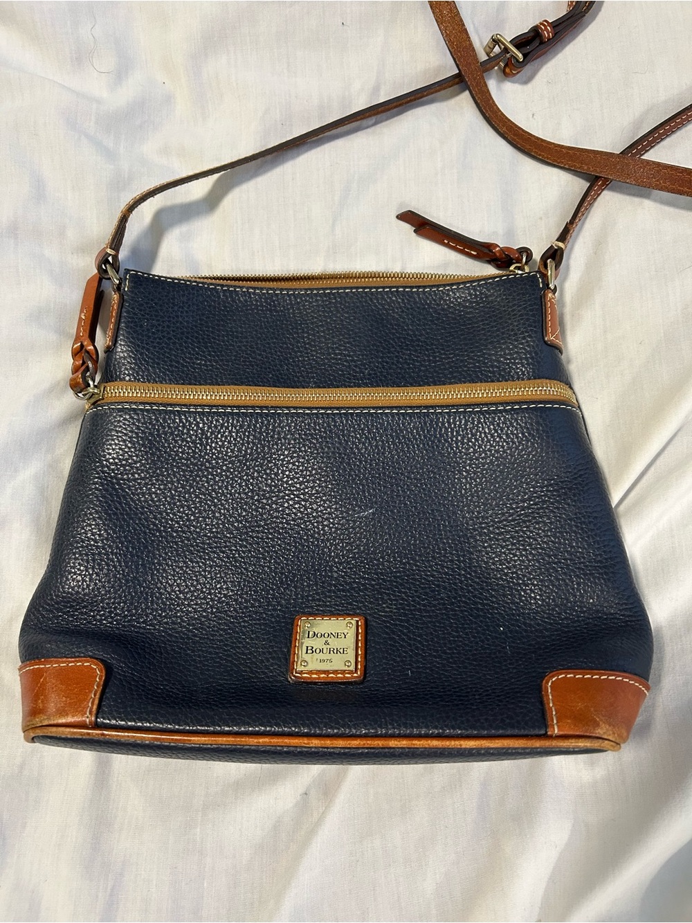 Dooney & Bourke Navy Pebble Leather Crossbody with Tan Trim and Gold Plaque